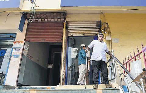 A person with disability struggling to walk down a bank ATM at Woraiyur in Tiruchy. (Photo | M K Ashok Kumar, EPS)