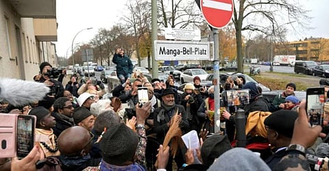 People gather at an unveiling ceremony of a new plaque to rename the 'Nachtigalplatz' square into 'Manga-Bell-Platz' in Berlin. (Photo | AFP)