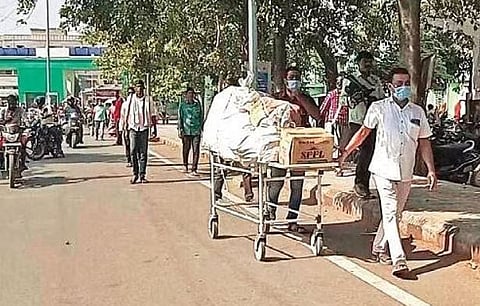 Oxygen cylinders being carried on stretchers at SCB Medical College and Hospital in Cuttack on Friday | Express