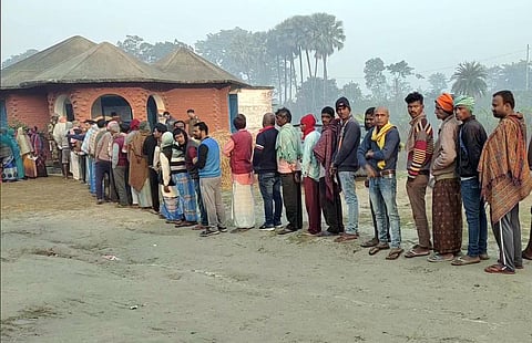 Voters wait in a queue to cast their vote for the Kurhani Assembly bypolls, at a polling station, in Muzaffarpur, Dec. 5,2022. (Photo | ANI)