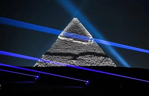 The Pyramid of Khafre (Chephren) is illuminated during the Christian Dior fashion show at the Giza Pyramids Necropolis on December 3, 2022 | AFP