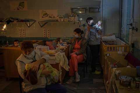 Hospital staff take care of orphaned children at the children's regional hospital maternity ward in Kherson, southern Ukraine | AP