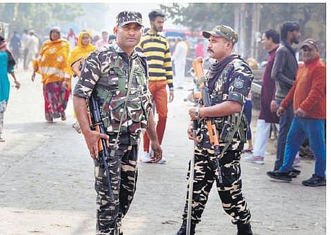 Security personnel stand guard near a polling station in Jahangirpuri | pti