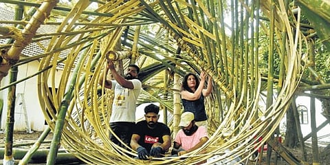 Assistants of artist Asim Waqif setting up his installation made out of various types of bamboo as part of the Kochi Muziris Biennale .(Photo | A Sanesh)