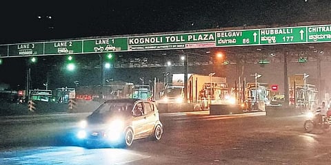 Vehicles pass through the Kognoli toll plaza along the Karnataka-Maharashtra border on Wednesday evening.