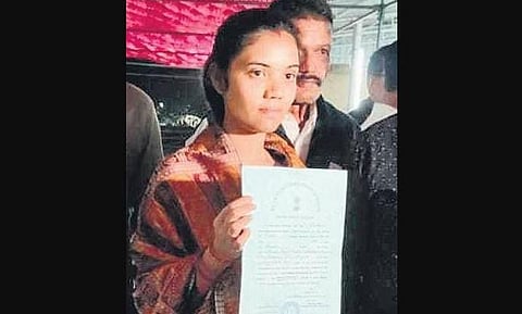 Barsha Singh Bariha with the winning candidate’s certificate