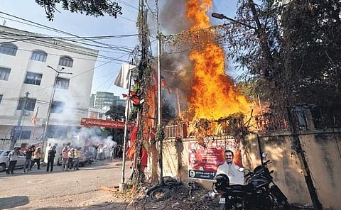 Flexis near the BJP office in Hyderabad catch fire from the crackers burst by party workers to celebrate the Gujarat Assembly results on Thursday | RVK RAO