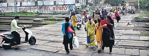 Pedestrians and motorcyclists cross the railway tracks at Chromepet near SDNP Vaishnav College in Chennai | Ashwin Prasath