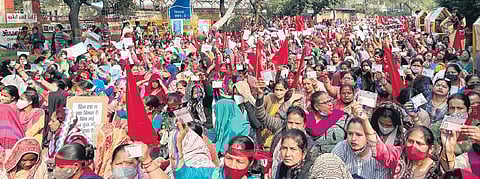 Section of the road near Vikas Bhawan has turned red with women holding red flags and posters. (Photo | Ankita Upadhyay)