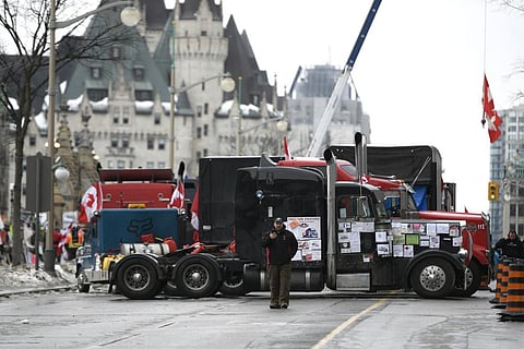 Trucks, are parked in front of the Chateau Laurier as a protest against COVID-19 restrictions continue in Ottawa. (Photo | AP)