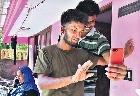 R Babu busy answering calls from his friends at his house in Cherad on Friday