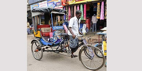 A cycle rickshaw rider plying on Big Bazaar Street in Tiruchy | MK Ashok Kumar