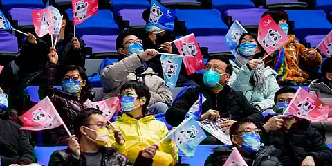 Spectators cheer during a preliminary round men's hockey game between China and Canada at the 2022 Winter Olympics, Sunday, Feb. 13, 2022, in Beijing. (Photo | AP)