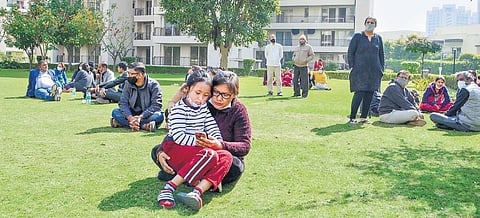 Residents take shelter in an open area after a portion of a building of Chintels Paradiso housing society collapsed in Gurugram on February 11. (Photo | PTI)