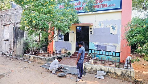 Workers build a ramp outside the Child Welfare Committee office at Royapuram so it can be used as a polling booth, in Chennai on Tuesday | DEBADATTA MALLICK