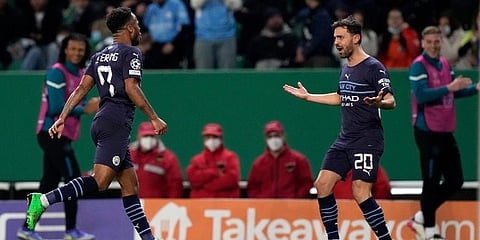 Manchester City's Raheem Sterling, left, celabrates with Bernardo Silva during their Champions League round of 16 match against Sporting CP in Lisbon, Feb 15, 2022. (Photo | AP)