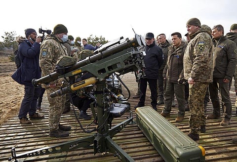 Ukrainian President Volodymyr Zelenskyy, center left, inspects anti-aircraft weapons during a military drill outside the city of Rivne, northern Ukraine. (Photo | AP)