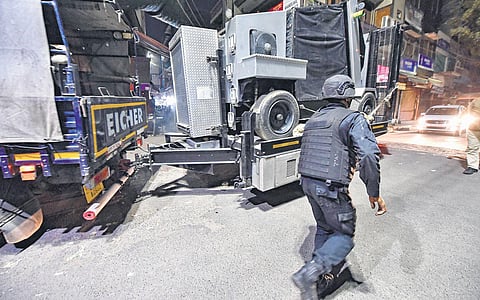 An NSG personnel escorts the Bomb Disposal Squad vehicle carrying the IED found in Old Seemapuri on Thursday, Feb 17, 2022.  (Photo | PTI)