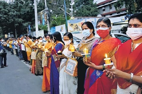 Opposing disinvestment in LIC, the All India Insurance Employees Association hold a candlelight protest in Hyderabad