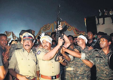 Mulugu SP Sangram Singh G Patil opens fire to welcome Samakka in Medaram village on Thursday.