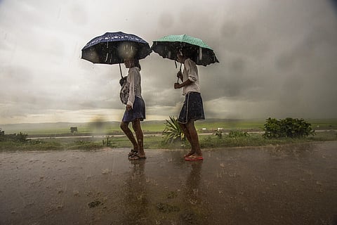 Schoolgirls make their way under heavy rain in Antananarivo, Madagascar. (File Photo | AP)