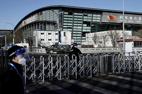 Chinese security stand guard outside the National Indoor Stadium ahead of the 2022 Winter Olympics. (Photo | AP)