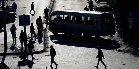 People are silhouetted on the streets as vehicles block a main roadway during a general strike by public transport unions inBeirut, Lebanon, Feb 2, 2022. (Photo | AP)