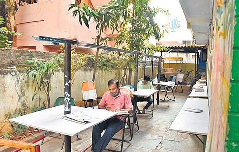 People read newspapers at Andhari Illu, Kothapet; (top) Dr Surya Prakash shows the collection of books at the Open House | S Senbagapandiyan