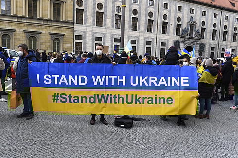 Protestors hold a banner to support the Ukraine during a demonstration alongside the Munich Security Conference in Munich, Germany. (Photo | AP)