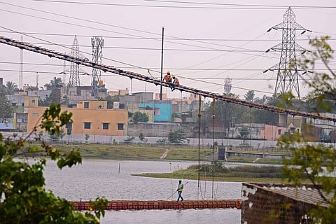 Labourers work on the suspension bridge above Villivakkam lake in Chennai. (Photo| Debadatta Mallick, EPS)