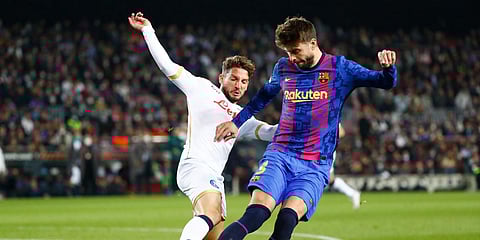 Napoli's Dries Mertens(L) and Barcelona's Gerard Pique vie for the ball during a Europa League match. (Photo| AP)