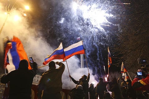 People celebrate the recognizing the independence waving Russian national flag in the center of Donetsk, the territory controlled by pro-Russian militants, eastern Ukraine. (Photo | AP)