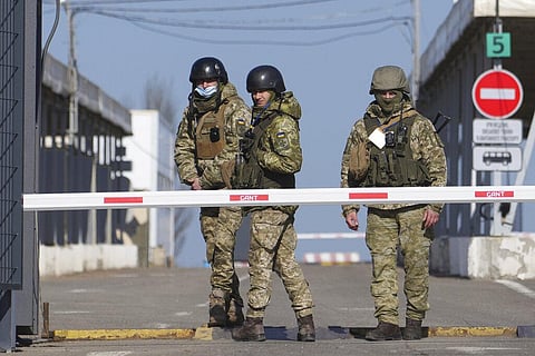 Ukrainian border guards stand at a checkpoint from territory controlled by Russia-backed separatists to the territory controlled by Ukrainian forces in Novotroitske, eastern Ukraine. (Photo | AP)