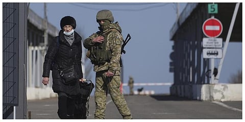 A woman crosses a checkpoint from the territory controlled by Russia-backed separatists to the territory controlled by Ukrainian forces in Novotroitske, eastern Ukraine  on Monday. (Photo: AP)