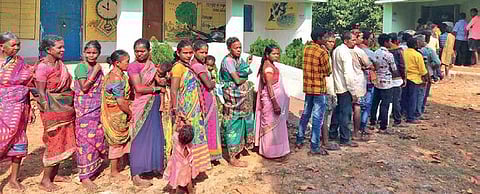 Villagers stand in a queue at the polling booth in Nagada on Tuesday. (Photo | EPS)