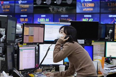 A currency trader talks on the phone at the foreign exchange dealing room of the KEB Hana Bank headquarters in Seoul, South Korea, Thursday, Feb. 24, 2022. (Photo | AP)