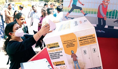 A woman drops a note at a ‘MyCityMyBudget’ drive in the city  | Express