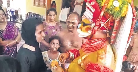 M T Ramlath interacting with the Muthappan Theyyam at Padna Kadappuram
