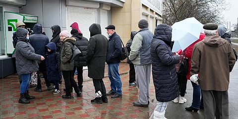 People line up to withdraw their money from an ATM in Mariupol, Ukraine. (File photo| AP)