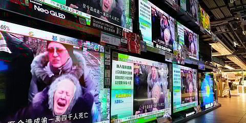 TV screens broadcast the news of Russian troops that have launched their attack on Ukraine, at an electrical store in Hong Kong. (Photo| AP)