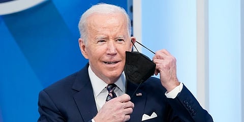 President Joe Biden removes his face mask to speak in the South Court Auditorium in the Eisenhower Executive Office Building. (Photo | AP)