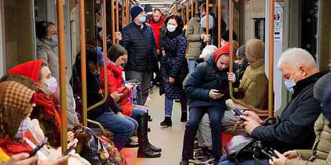People ride a subway carriage as some of them read on their smartphones in Moscow, Russia. (Photo | AP)