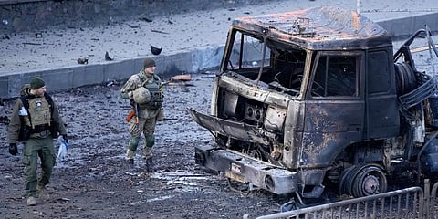 Ukrainian troops inspect the site following a Russian airstrike in Kyiv, Ukraine. (Photo | AP)