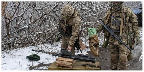 Ukrainian soldiers handle equipment outside Kharkiv, Ukraine, Saturday, February 26, 2022.