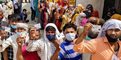 Citizens wait to cast their vote at a polling booth during the Uttar Pradesh Assembly elections. (Photo | PTI)