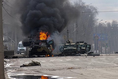A Russian armored personnel carrier burns amid damaged and abandoned light utility vehicles after fighting in Kharkiv, Ukraine. (Photo | AP)