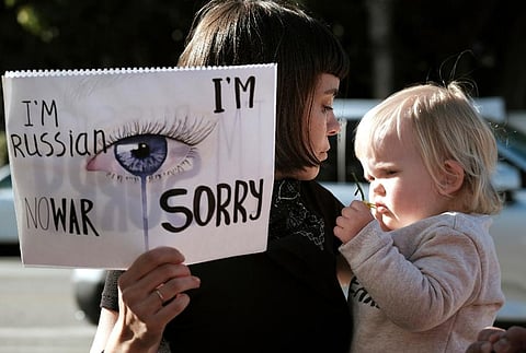 Katrina Repina from Pskov, Russia, and her daughter Zoey, join protesters at a demonstration against the Russian invasion of Ukraine. ( Photo |AP)