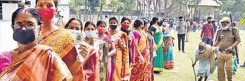 An elderly woman being helped as she arrives to cast her vote at a polling station at Balurghat in West Bengal on Sunday. (Photo| PTI)