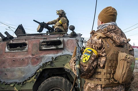 Ukrainian soldiers inspect a damaged military vehicle after fighting in Kharkiv, Ukraine, Sunday, Feb. 27, 2022. (Photo | AP)
