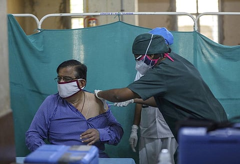 A health worker administers the third dose of Covisheild COVID-19 vaccine to an elderly person at a government hospital in Hyderabad. (Photo | AP)